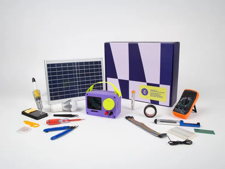 The complete EMA Kit — solar panel, Power Box, LED lamp, soldering iron, multimeter, tools and components, all laid out